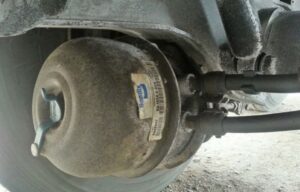 Brake chamber component with visible wear, illustrating potential air leakage issues related to brake system maintenance.