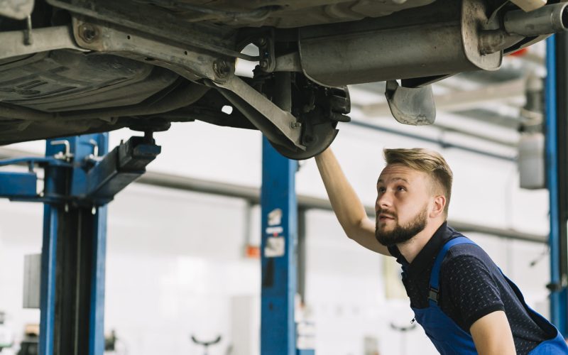 auto-mechanic-looking-car-s-bilge