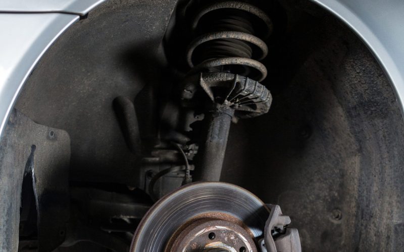 Close-up of car tyre and break disc at repair garage