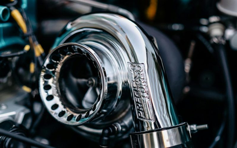 Turbocharger with polished chrome finish, showcasing intricate details and design, relevant to automotive performance and efficiency discussions.