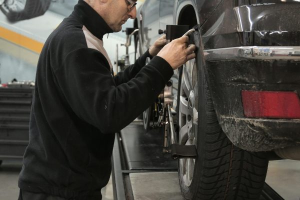 vehicle technician performing a wheel alignment