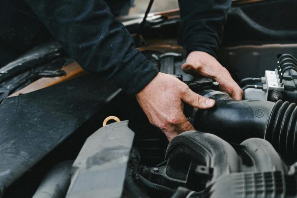 Mechanic working on vehicle cooling system maintenance