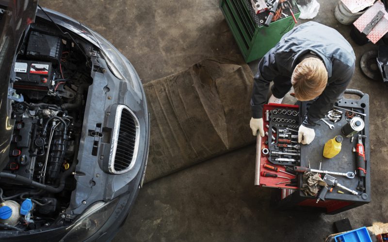 top-view-man-repairing-car